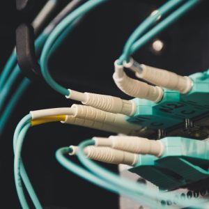 Detailed view of fiber optic cables and ports in a server room, showcasing connectivity.